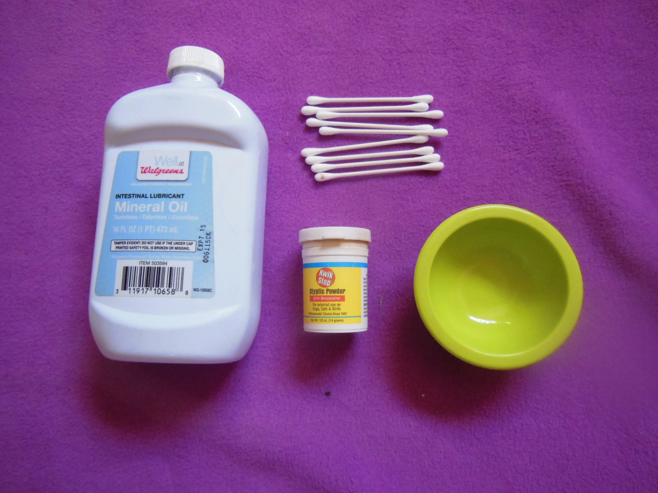 scent gland cleaning tools: minerial oil, cotton swab, quick stop and small bowl.