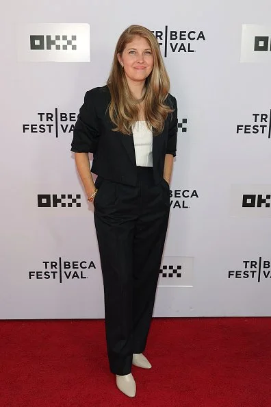 Jamie Boyle at Tribeca in black tailoring, a white top, and white heels