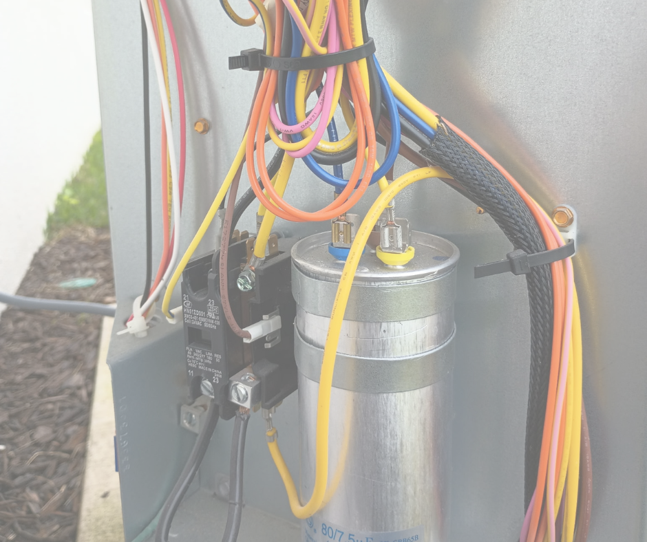 Electrical wiring and components inside an electrical panel box, including a relay, wires in multiple colors, and a cylindrical metallic component.