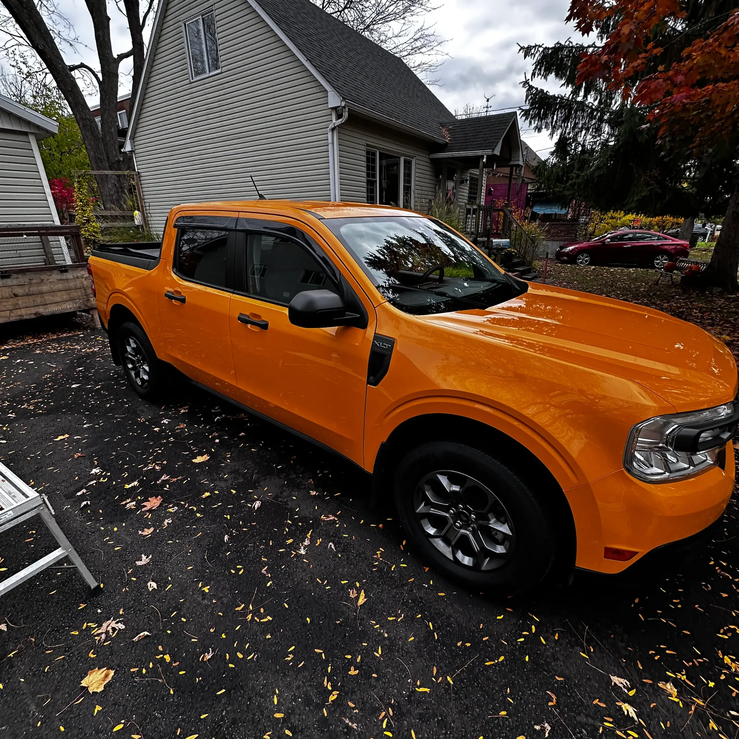 Orange pickup truck parked on a driveway