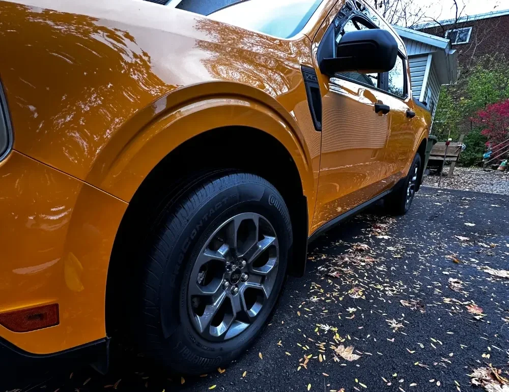 A close-up of an orange pickup truck
