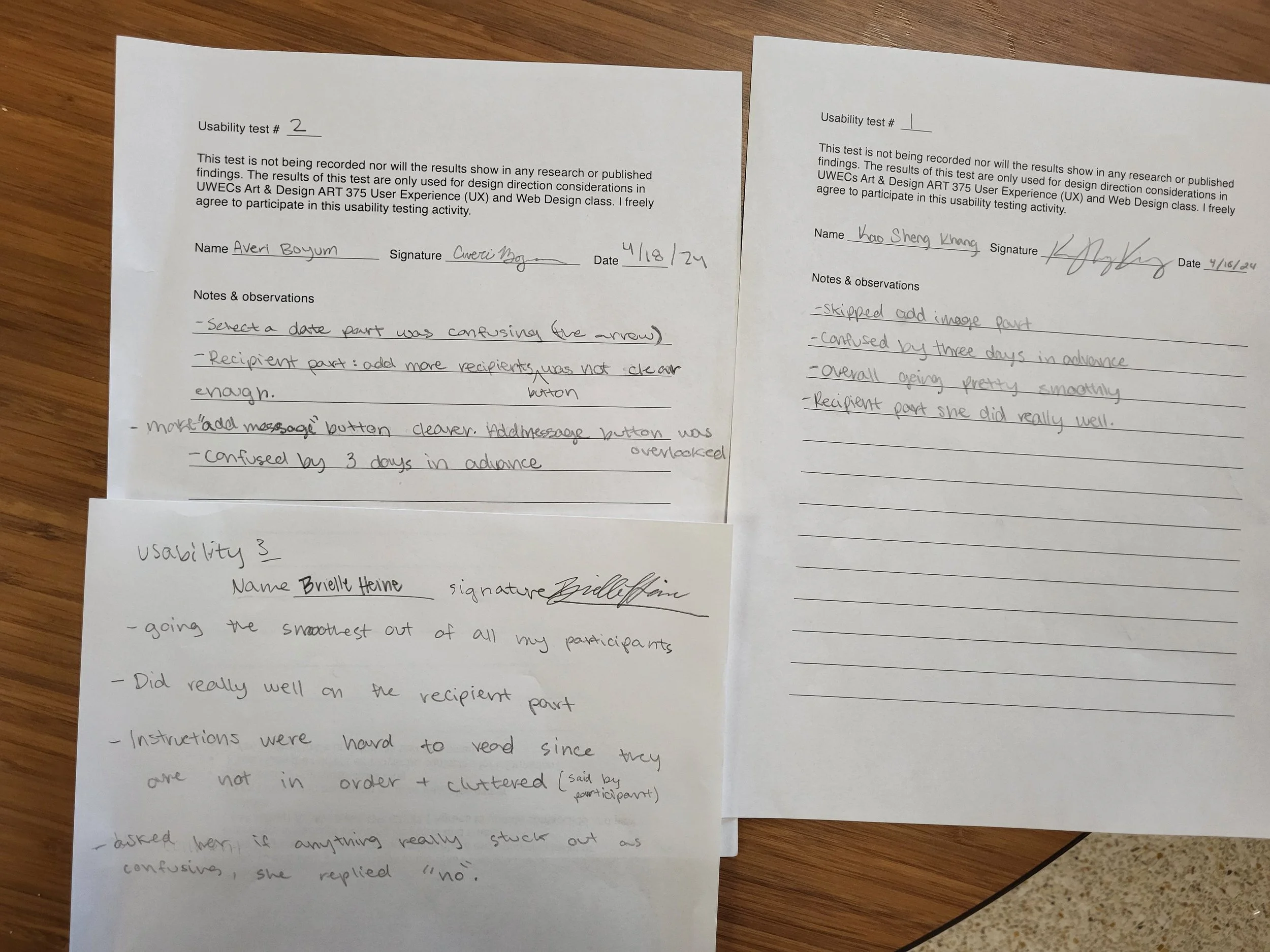 Three sheets of paper on a wooden table with handwritten notes about usability testing, including feedback and observations from participants.