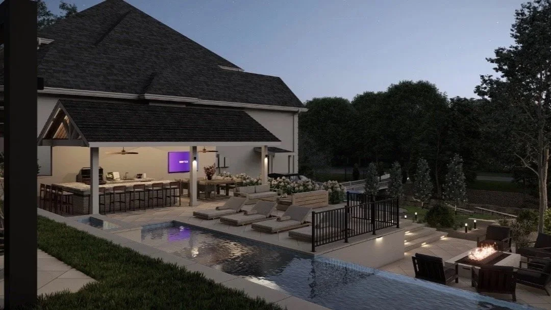A backyard outdoor area at night featuring a swimming pool, sun loungers, a covered patio with a dining table, chairs, and ceiling fans, surrounded by trees and landscaped garden lighting.