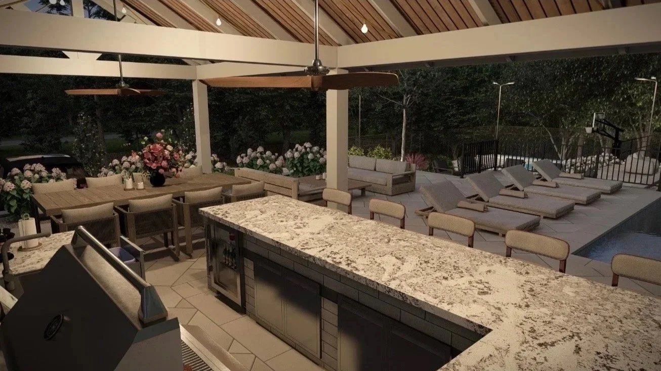 Outdoor patio area at night with lounge chairs, tables, flowers, a pool, and a kitchen area with a granite countertop.