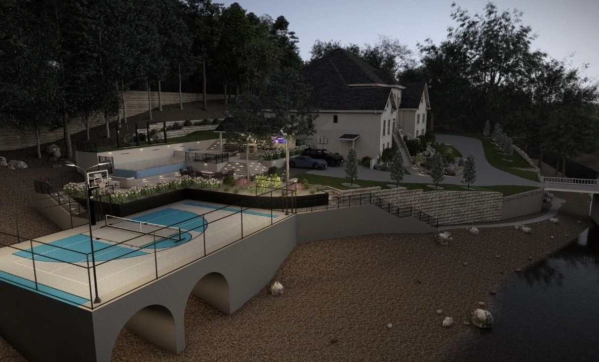 A modern house with landscaped yard, outdoor pool, basketball court, and a lakeside area, during evening with streetlights on.