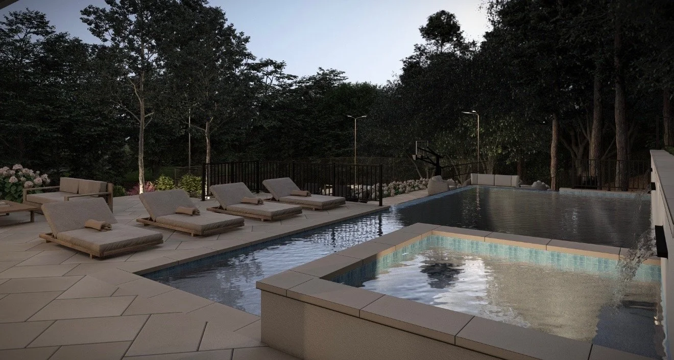 An outdoor swimming pool area at twilight with lounge chairs, cushions, and a view of surrounding trees.