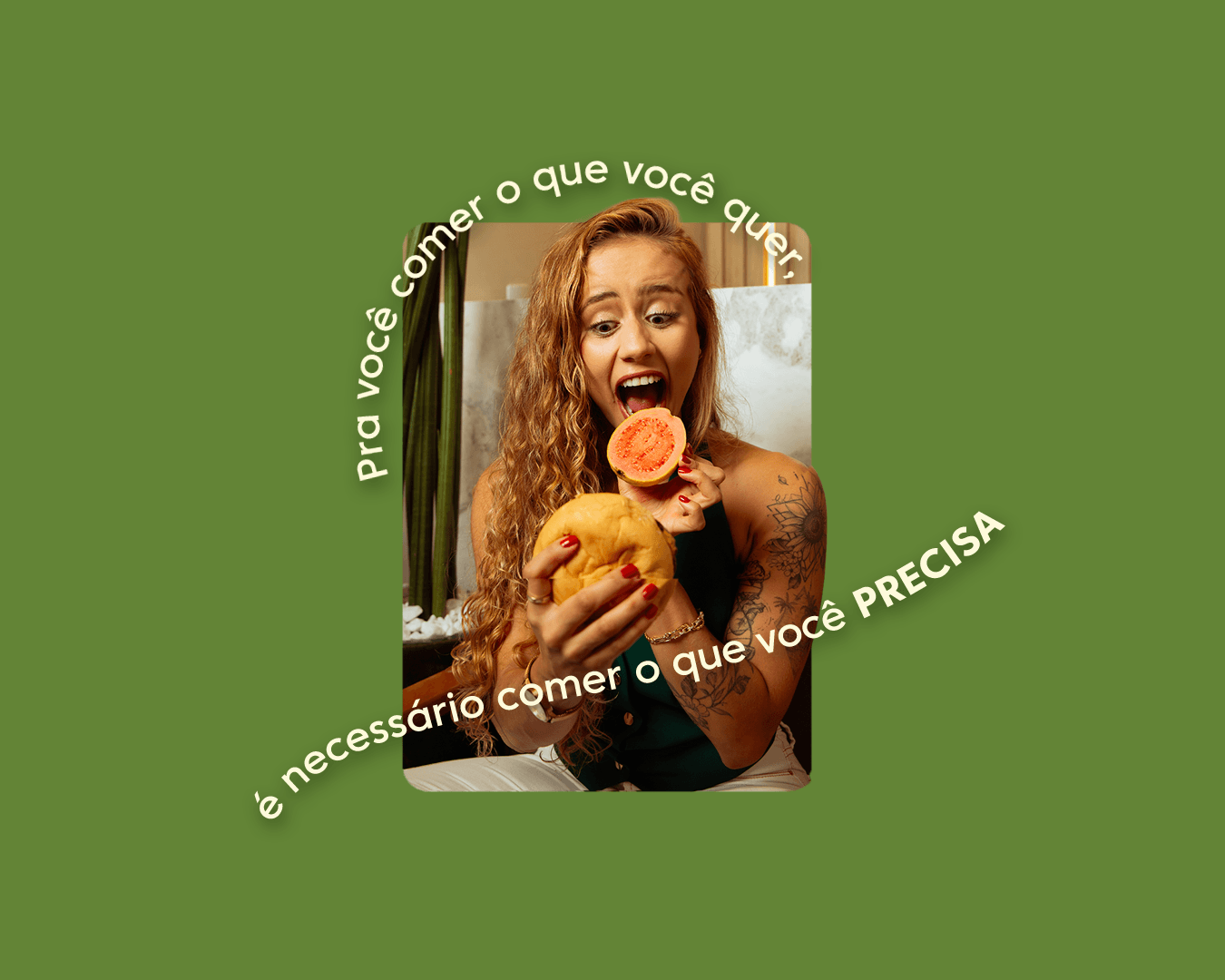 A woman with long curly hair holding a yellow mango and a sliced papaya, about to eat the papaya, in a restaurant setting.