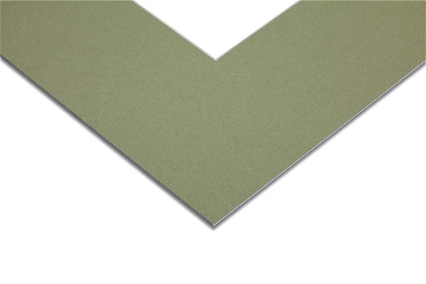 Close-up of a corner of a green sheet of paper or card stock.