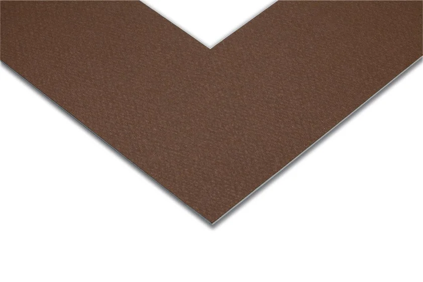 Close-up of a brown textured paper or fabric with a white triangular corner.