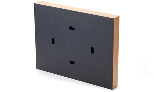 A rectangular black foam panel with a peach-colored edge, featuring three holes on the surface.