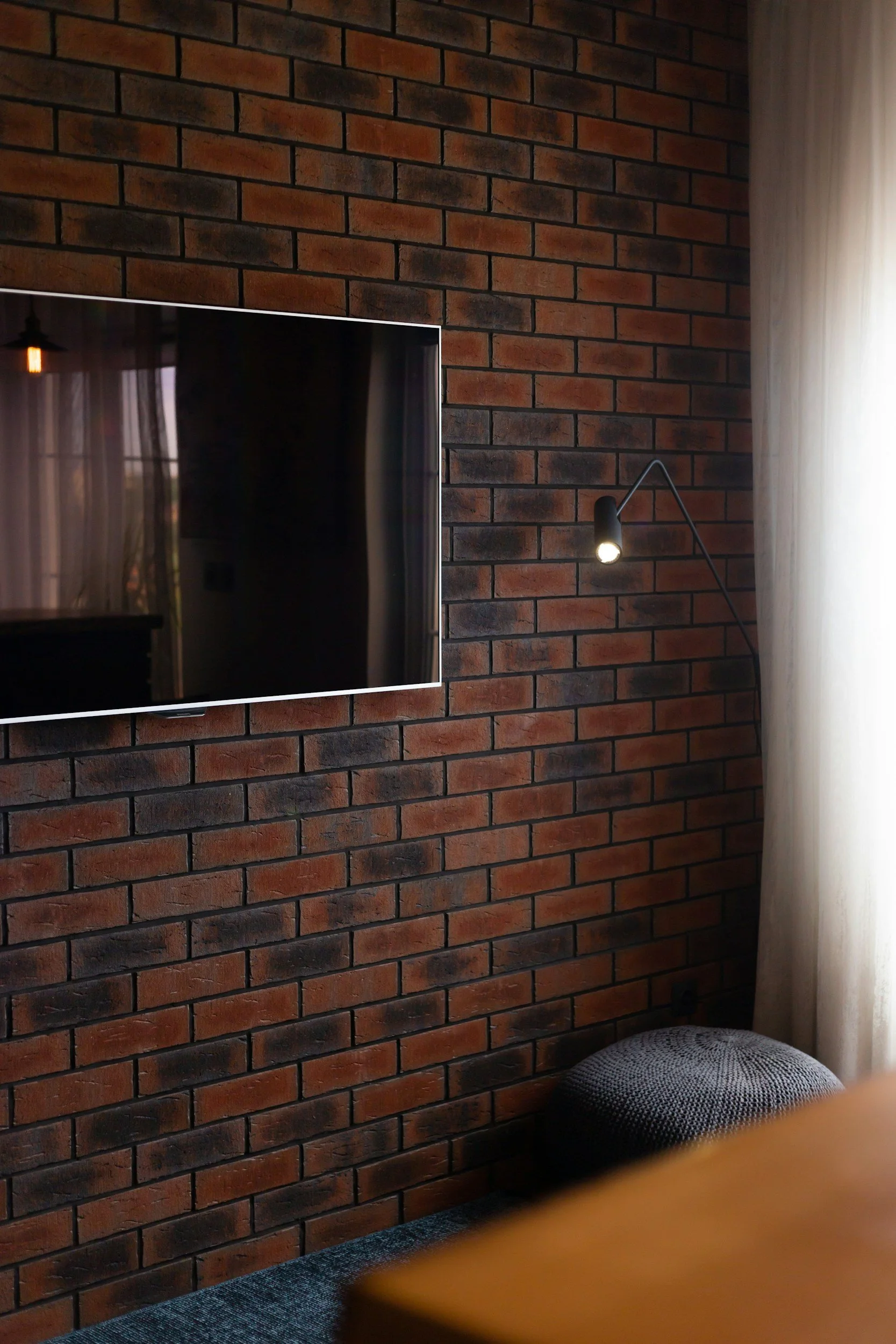 wall mounted tv on brick wall