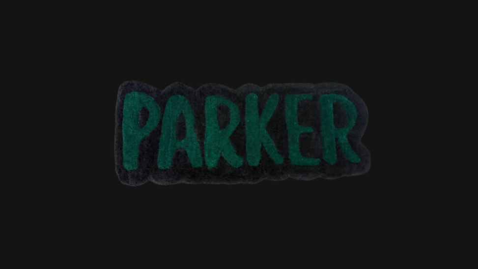 A Green and Black custom name rug, on a black background.