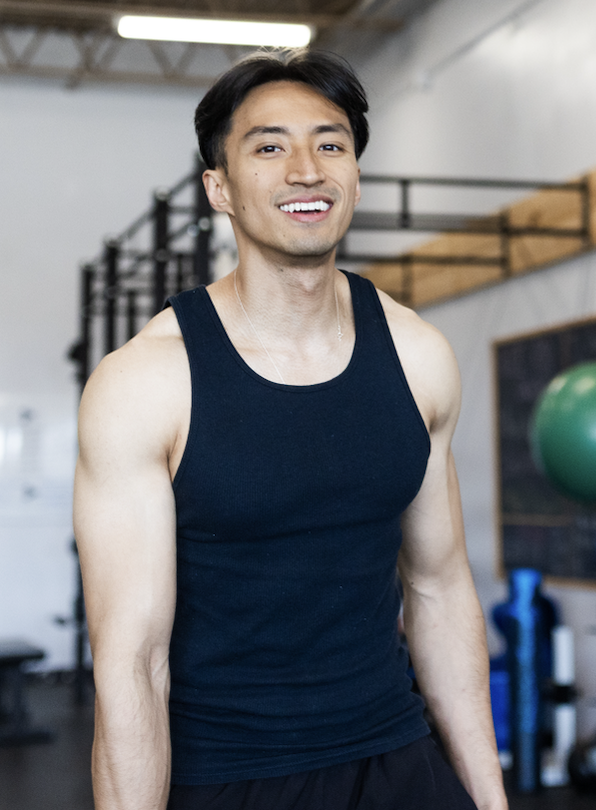 Frank Chen fitness coach standing in a gym offering personalized online fitness coaching