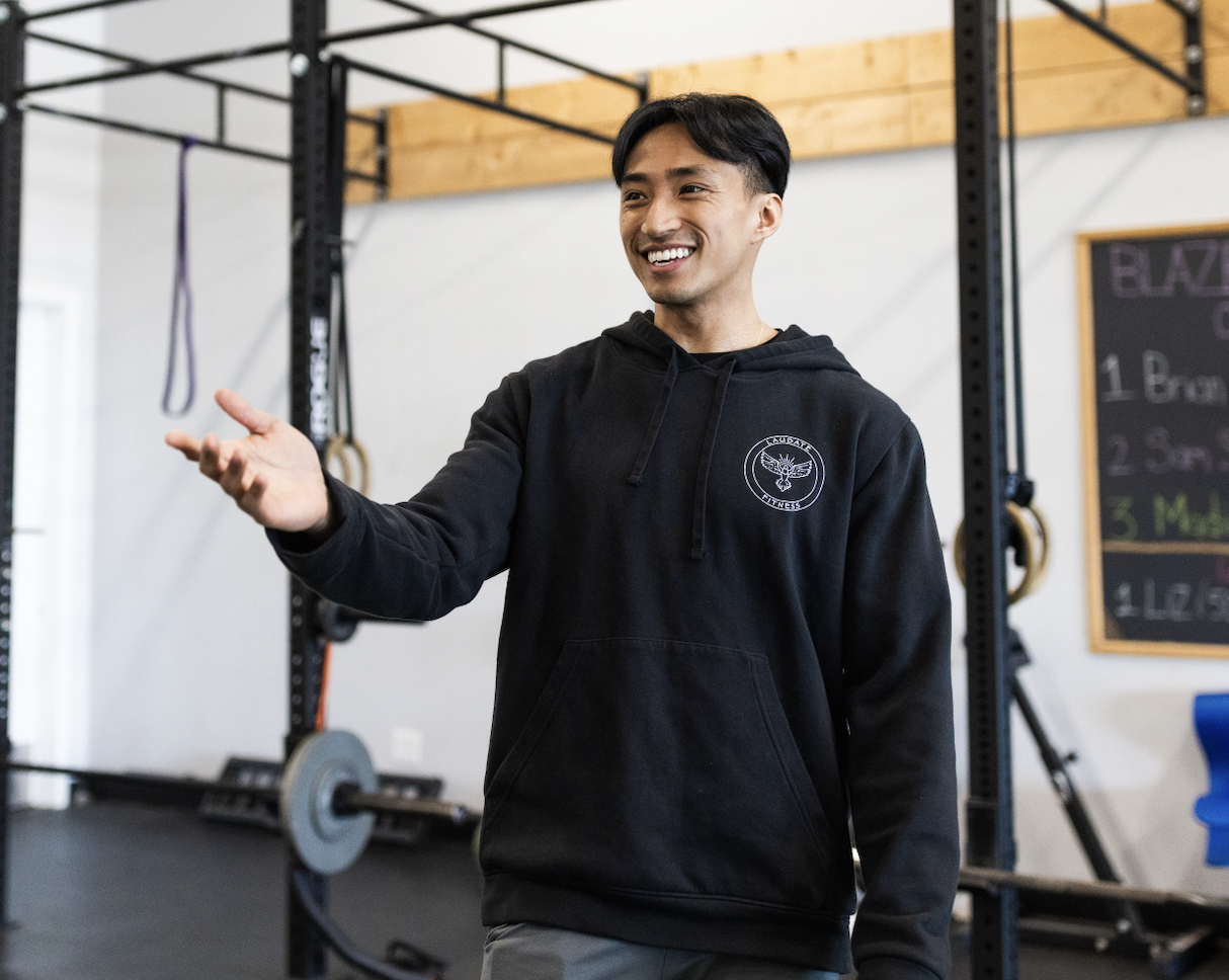 Frank Chen fitness coach speaking and leading training in a gym environment