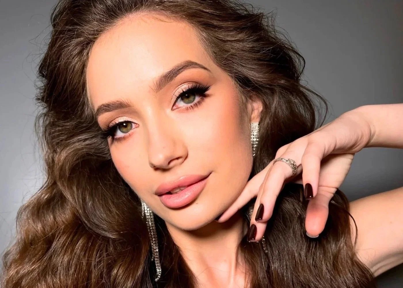 Glam close-up with winged eyeliner and glossy nude lip