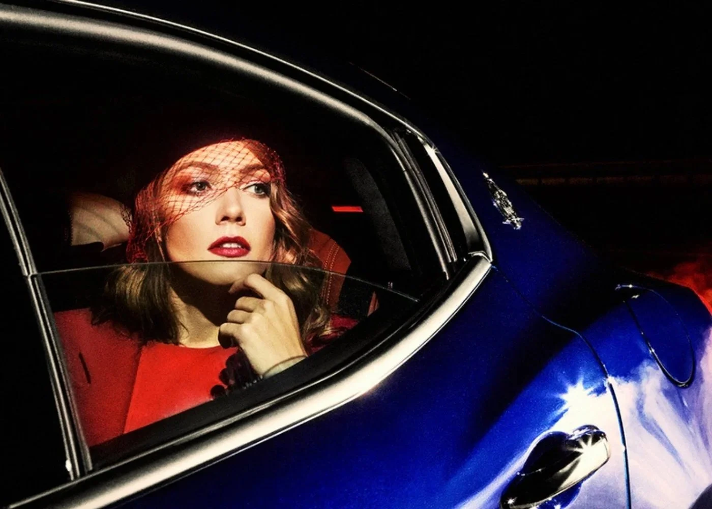 Editorial car portrait with red lipstick and dramatic eye makeup