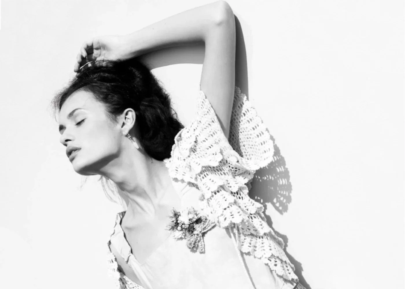 Black-and-white editorial portrait with soft contour and clean eye makeup