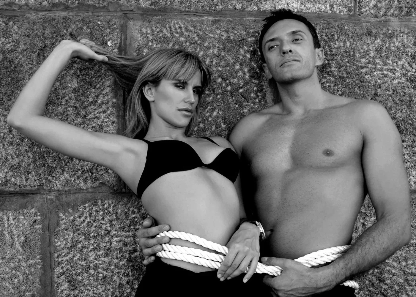 Black-and-white fashion couple portrait with minimal makeup and studio lighting