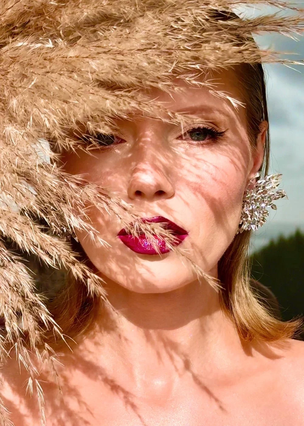 Fashion editorial makeup with bold lip and luminous skin