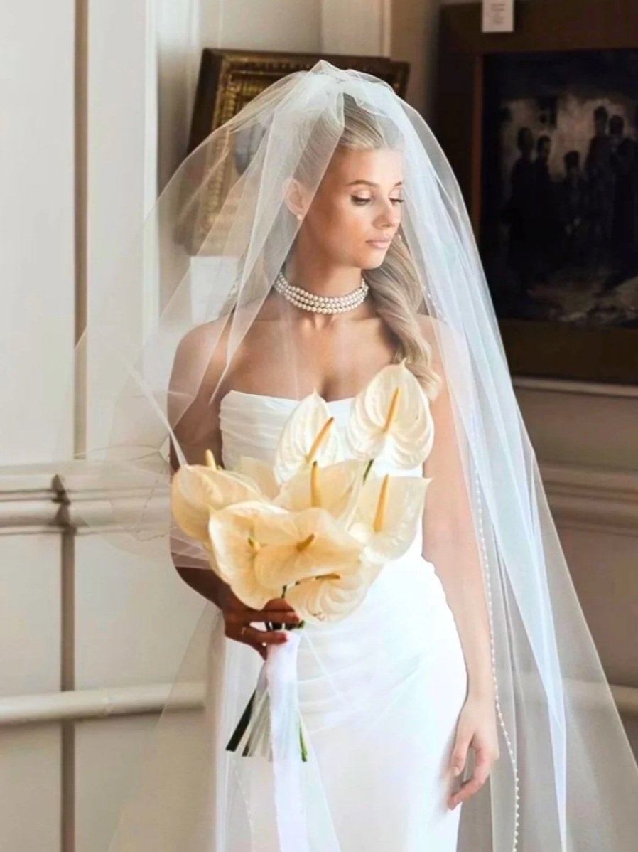 Classic bridal portrait with veil and bouquet, refined long-wear wedding makeup