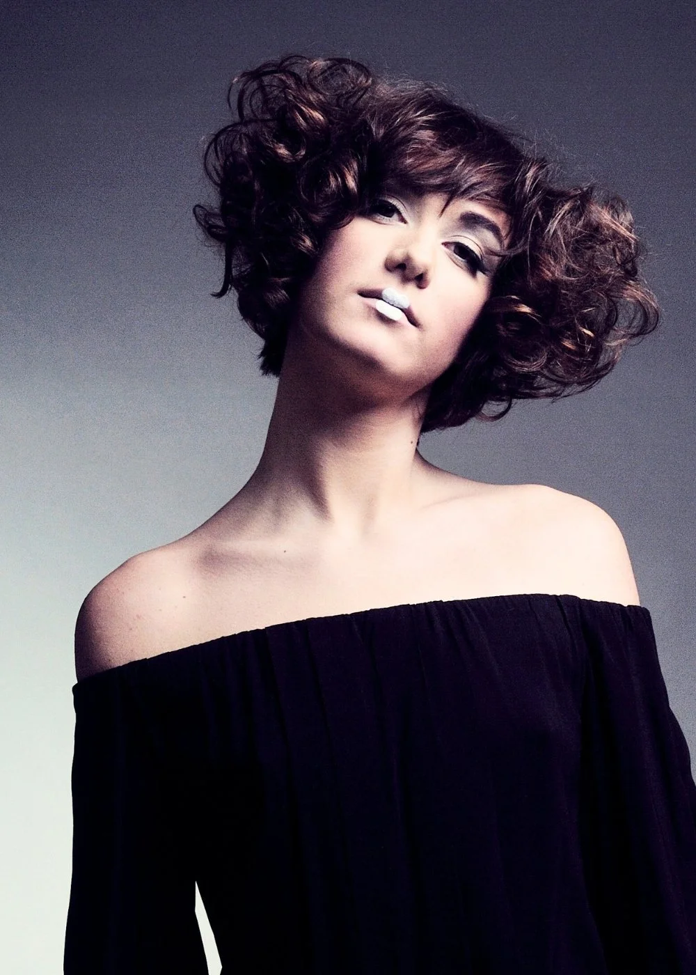 Editorial makeup with sculpted cheekbones and soft smoky eyes