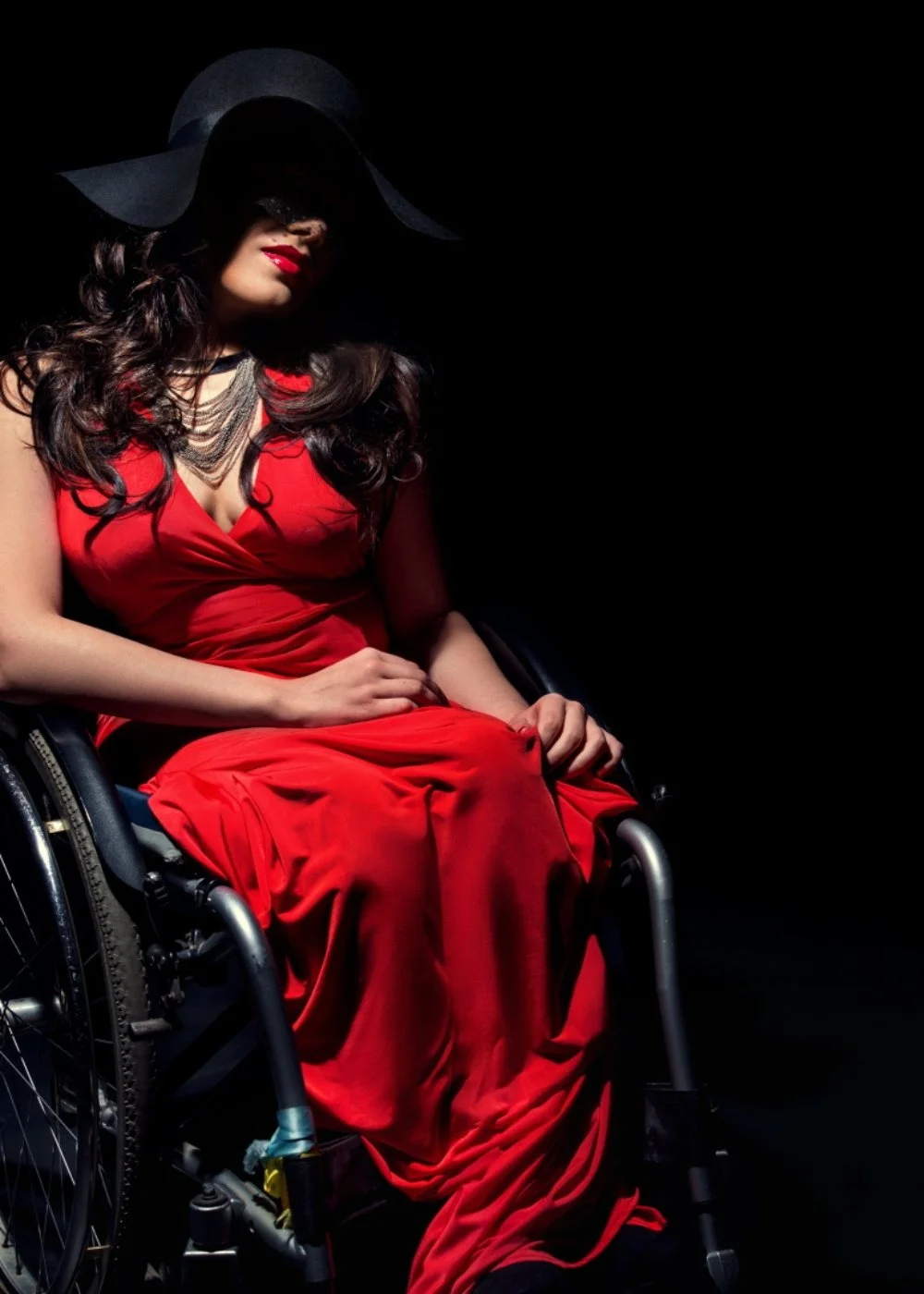 Glam editorial makeup for a fashion shoot — defined eyes, polished skin, dramatic red look