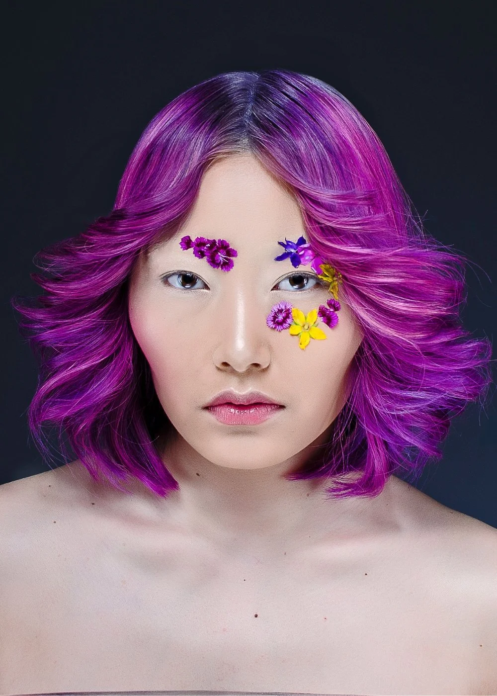 Creative beauty makeup with crystal accents for a studio photoshoot — bold, artistic look