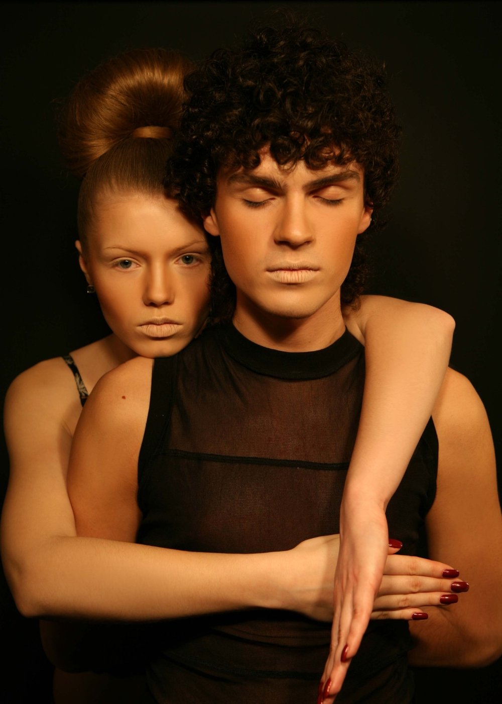 Moody couple portrait with cinematic lighting and clean makeup