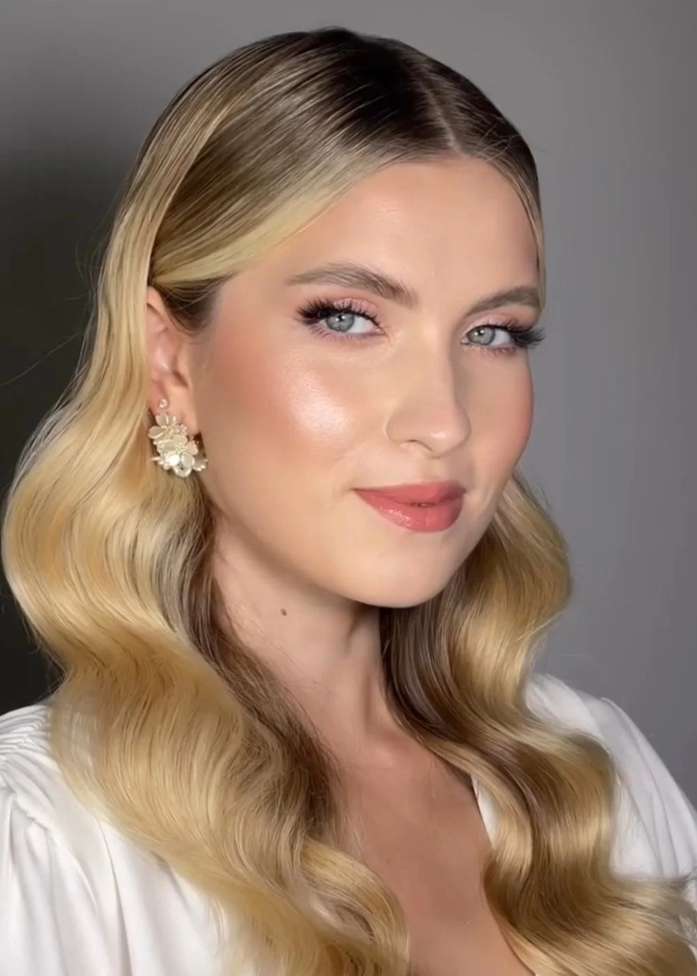 Beauty portrait with soft smoky eye, glossy nude lip, and polished waves