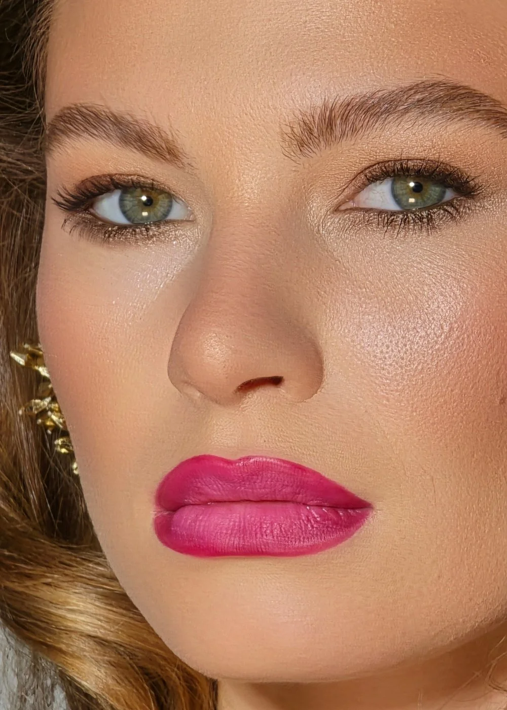 Close-up beauty portrait with soft glam eye makeup and bright pink lipstick