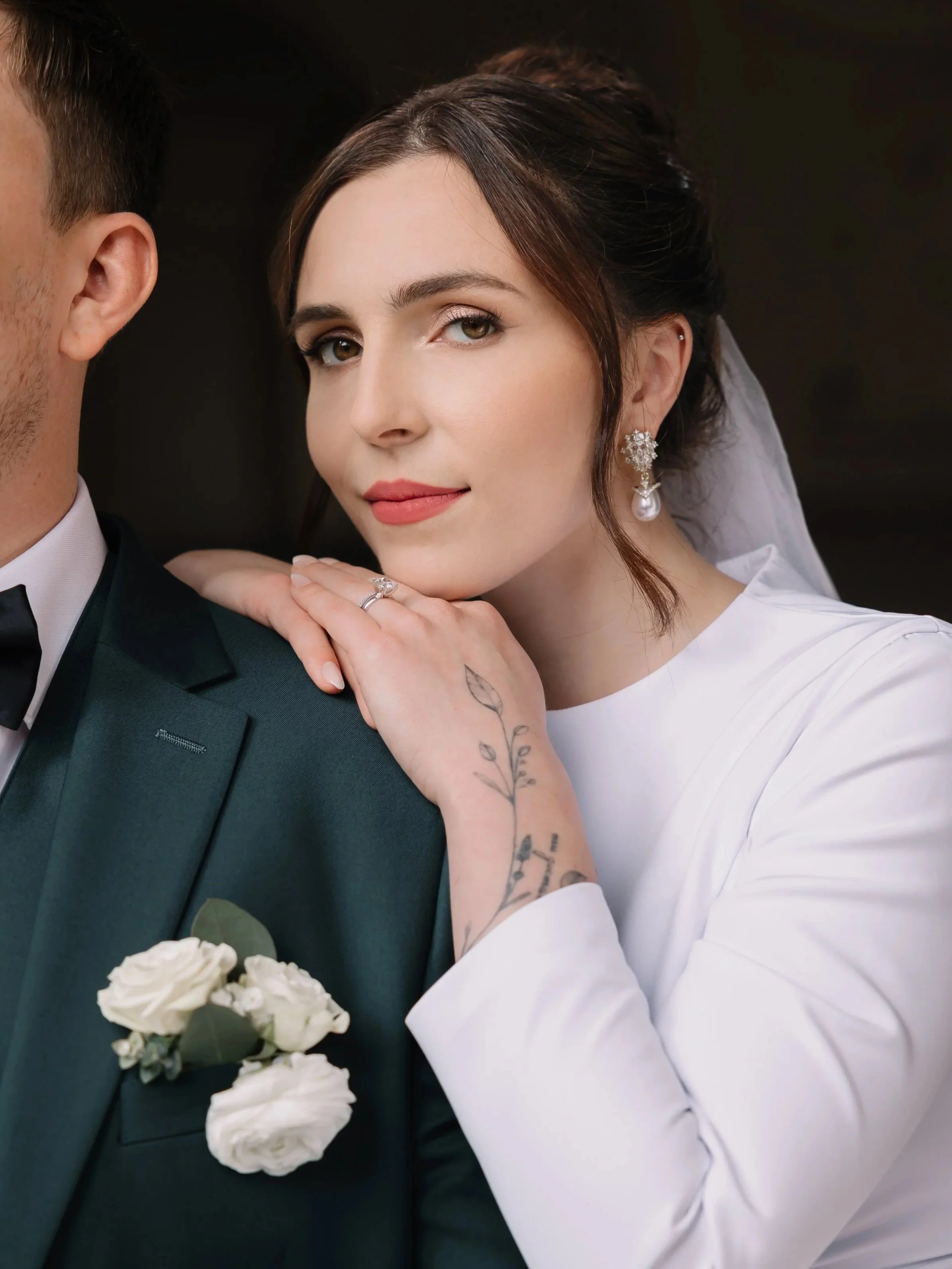 Bride with soft, refined wedding makeup and veil, portrait with groom