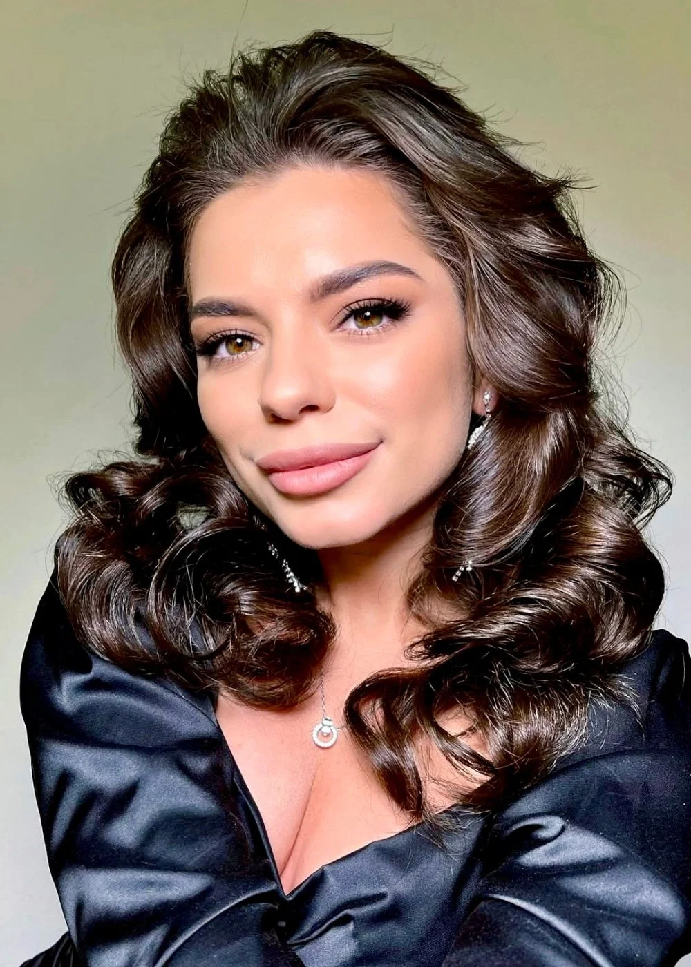 Beauty portrait with soft curls and polished evening makeup