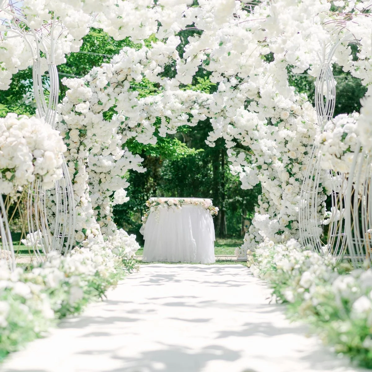 White floral wedding archway and aisle decor