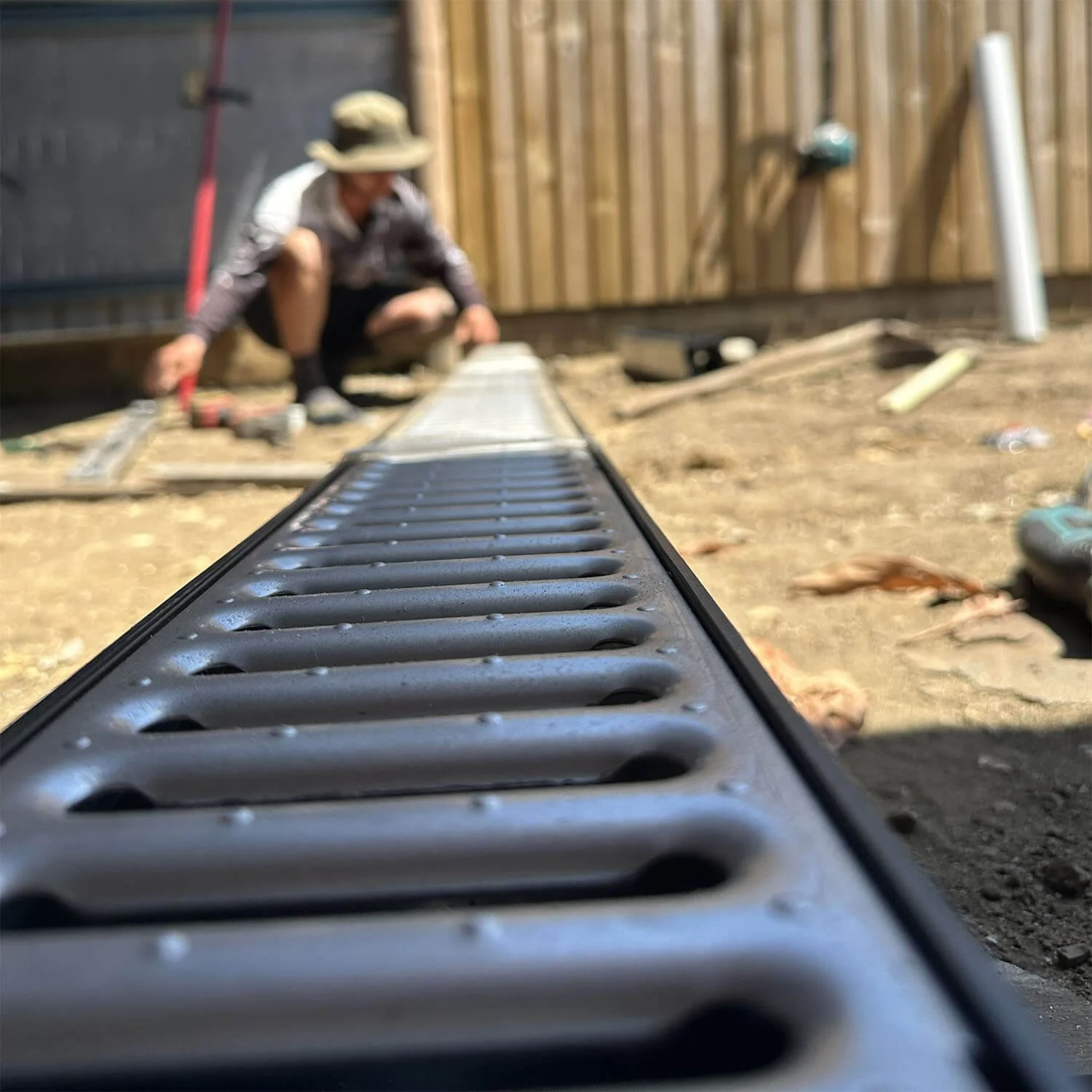A stylised photo of a drain and Michael sat blurred in the background.