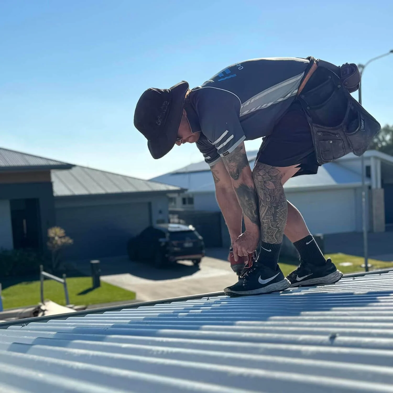 A photo of Michael from Ezi Group working on a roof.
