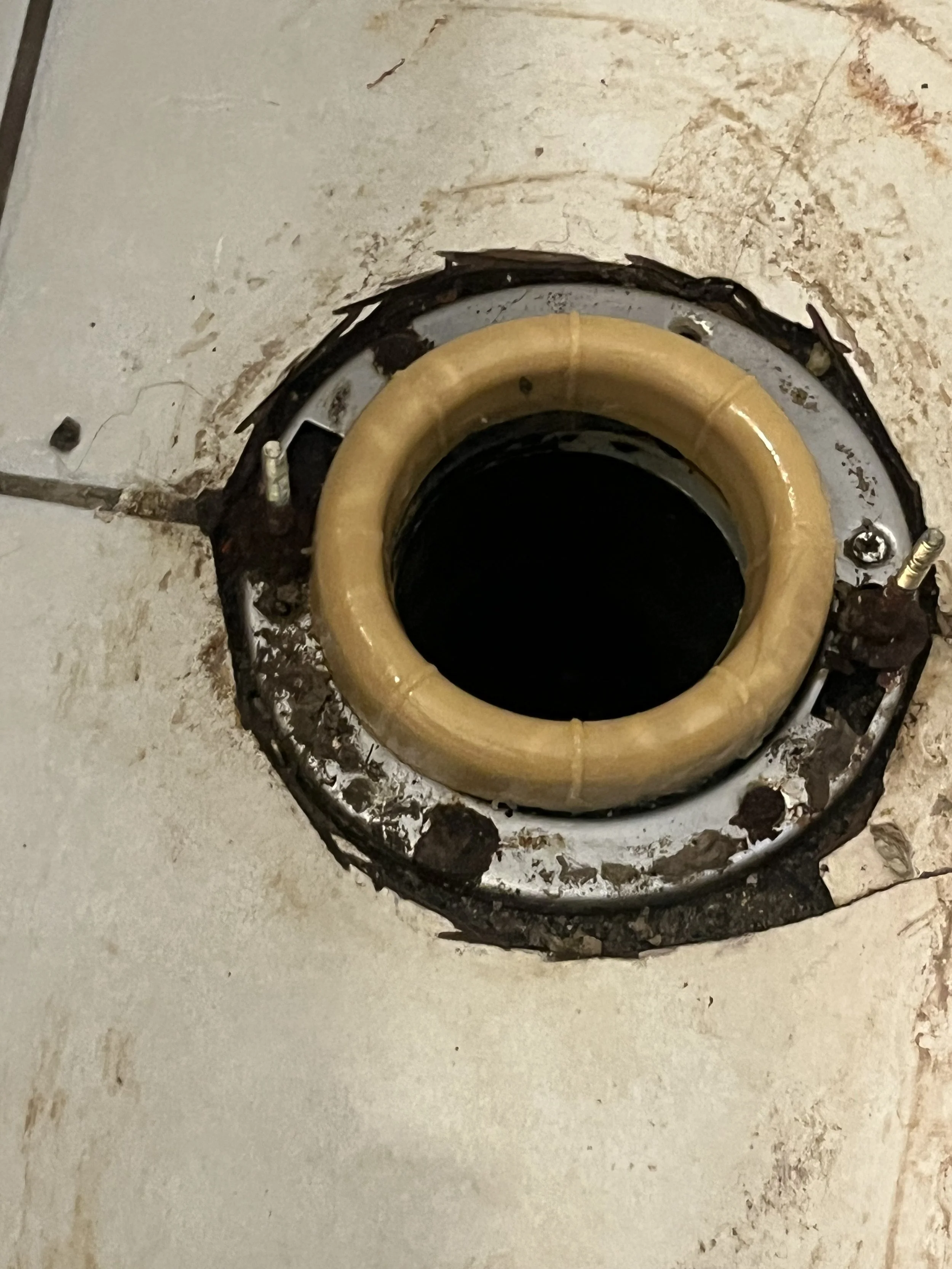 toilet flange with a wax ring and rough-in pipe, ready for toilet installation.