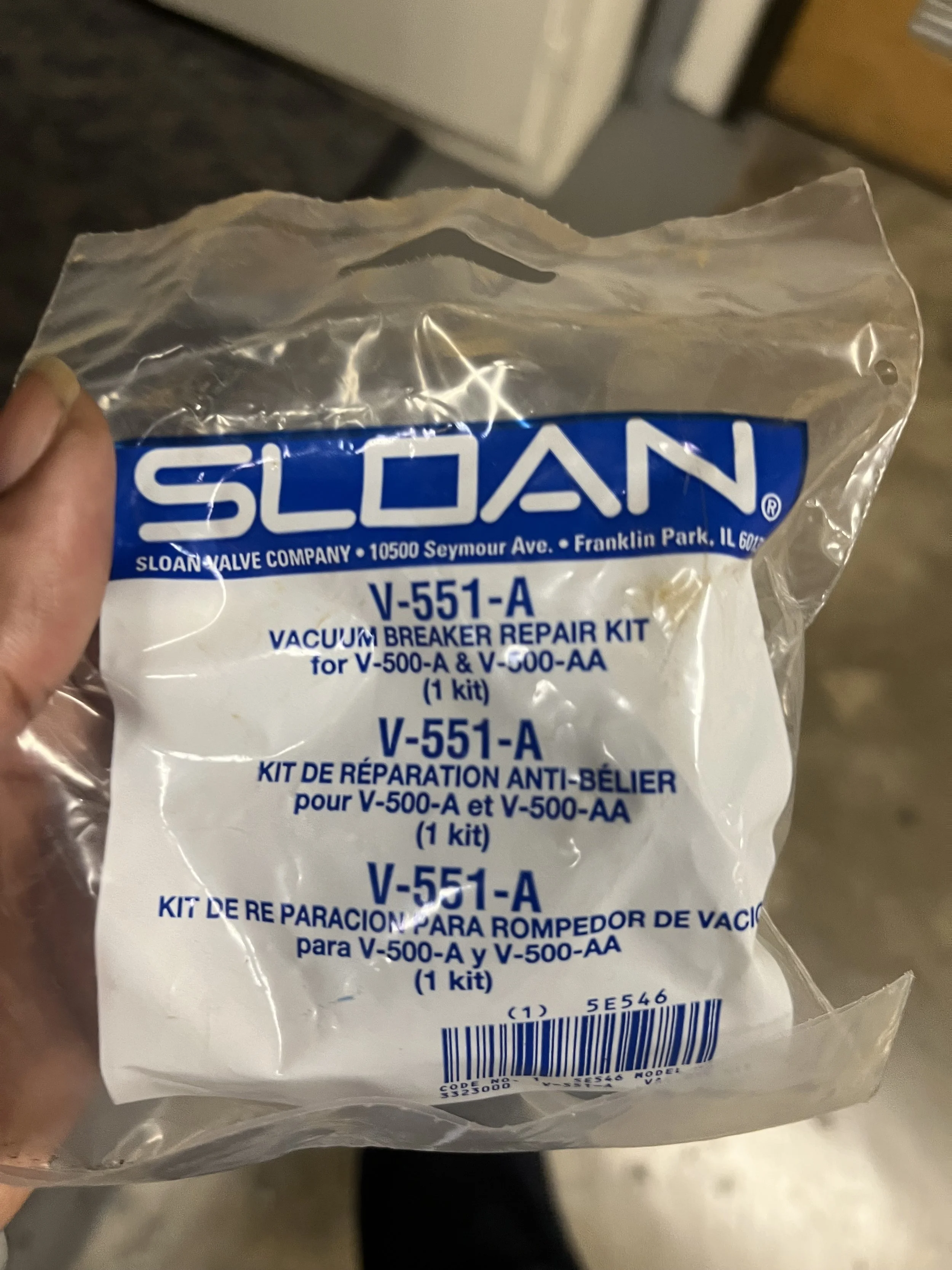 A clear plastic bag labeled 'SLOAN' containing a vacuum breaker repair kit, model V-551-A