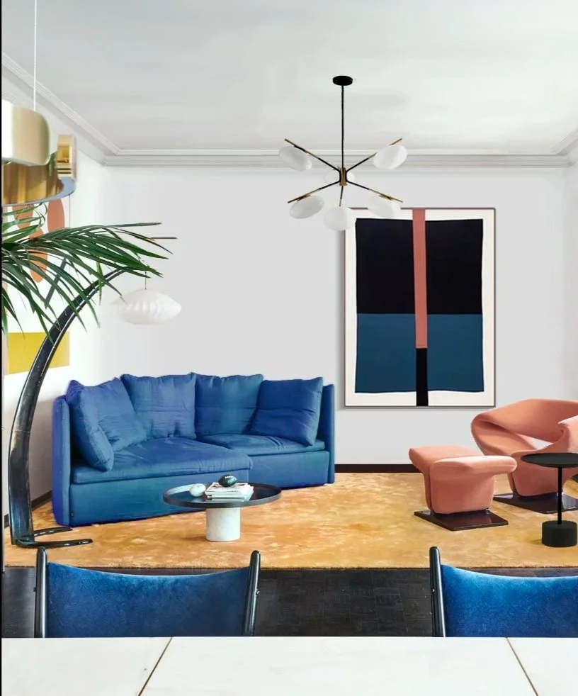 Modern living room with a blue sofa, pink armchair, abstract artwork on the wall, and a contemporary chandelier.