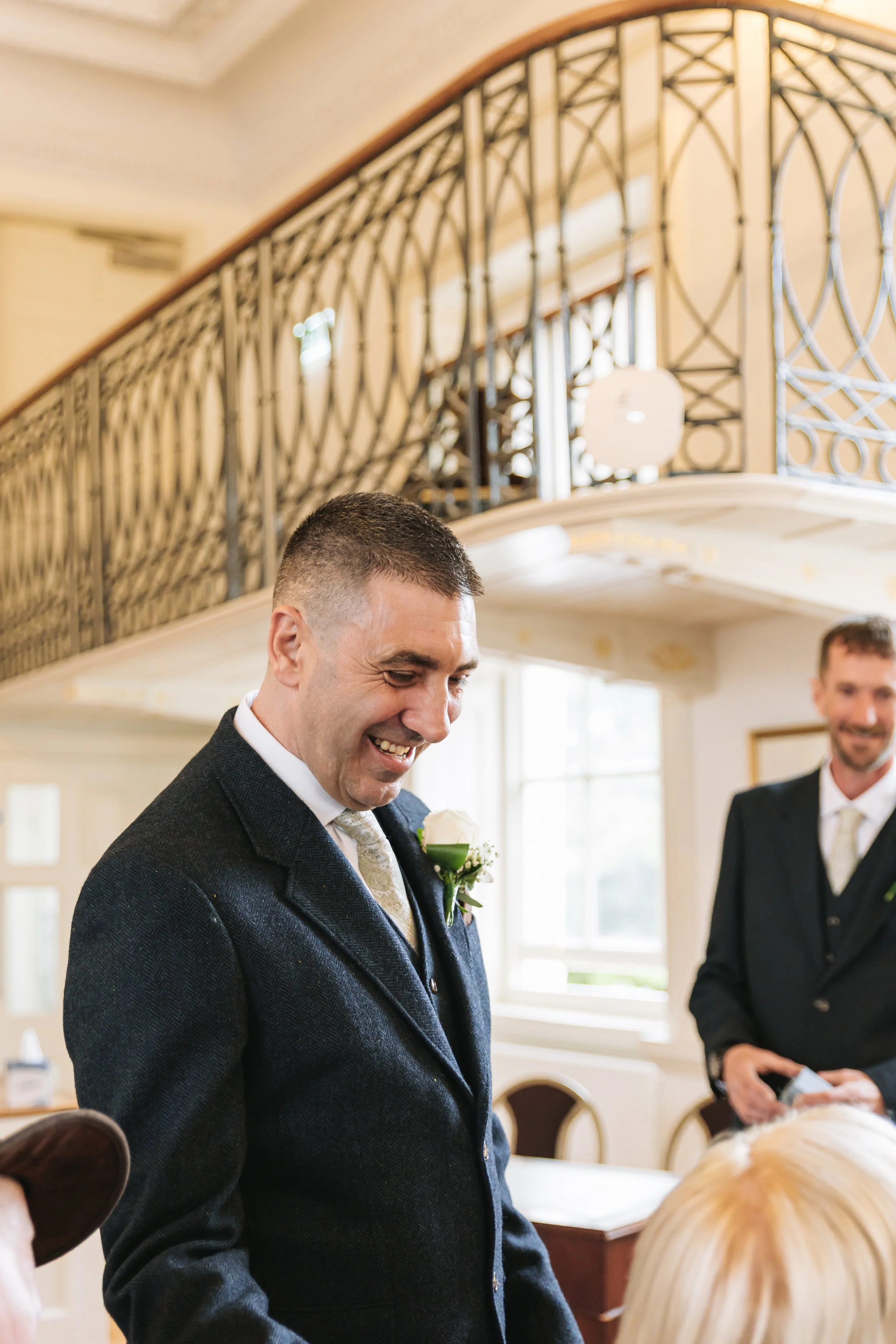 groom-smiling-with-wedding-guests-poole-guildhall.jpg