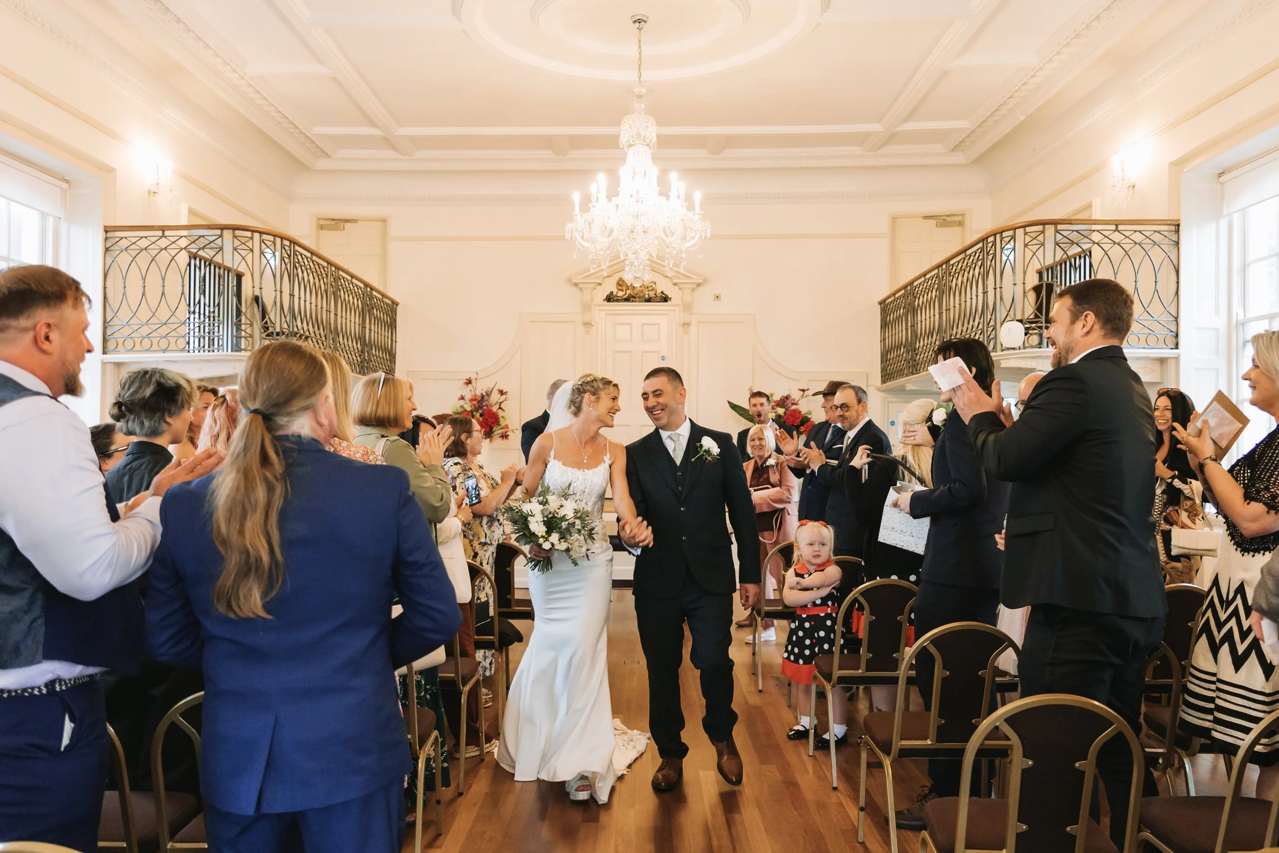 Bride and groom walking down aisle at Poole Guildhall, Dorset