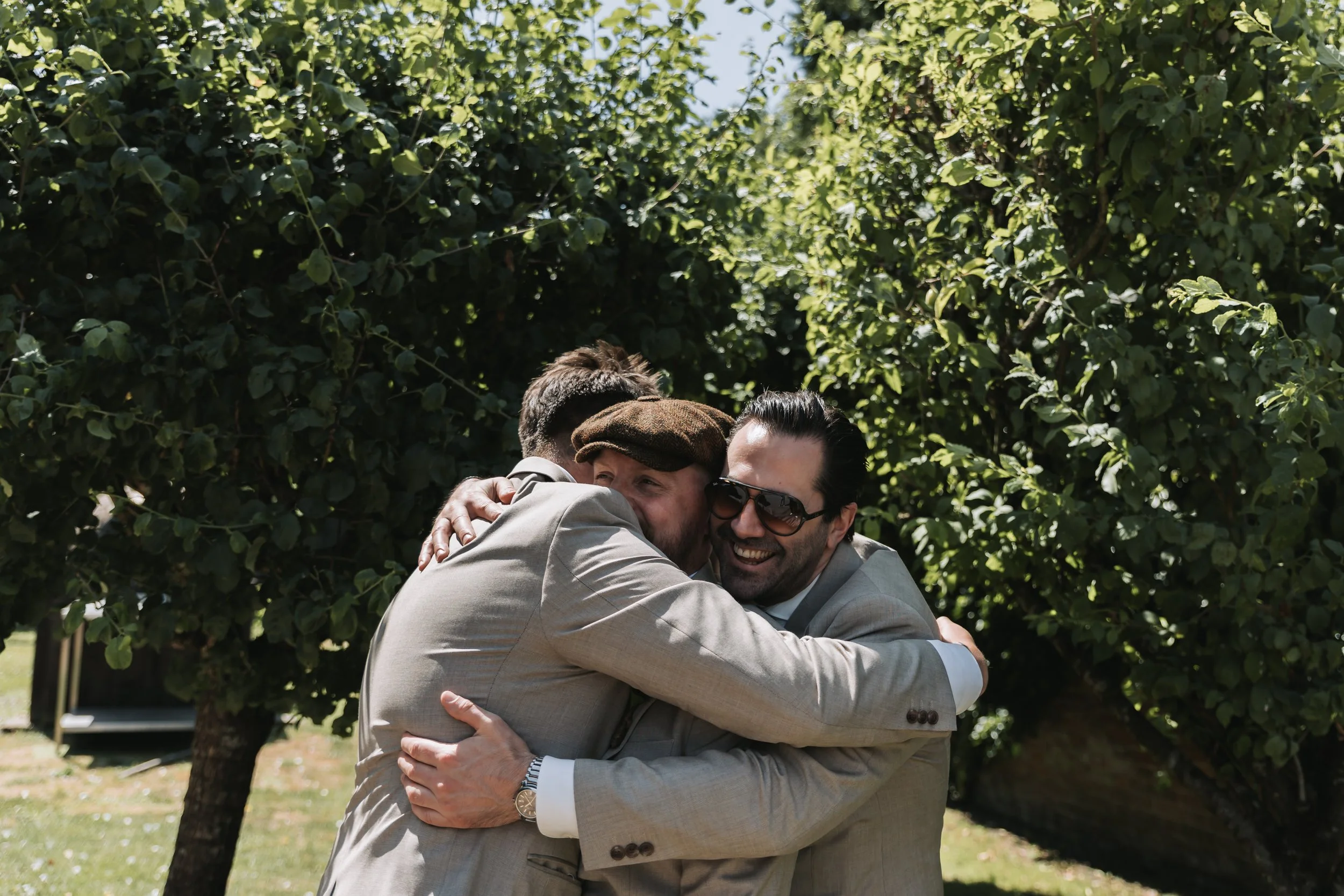 best-men-hugging-groom-kings-chapel.jpg