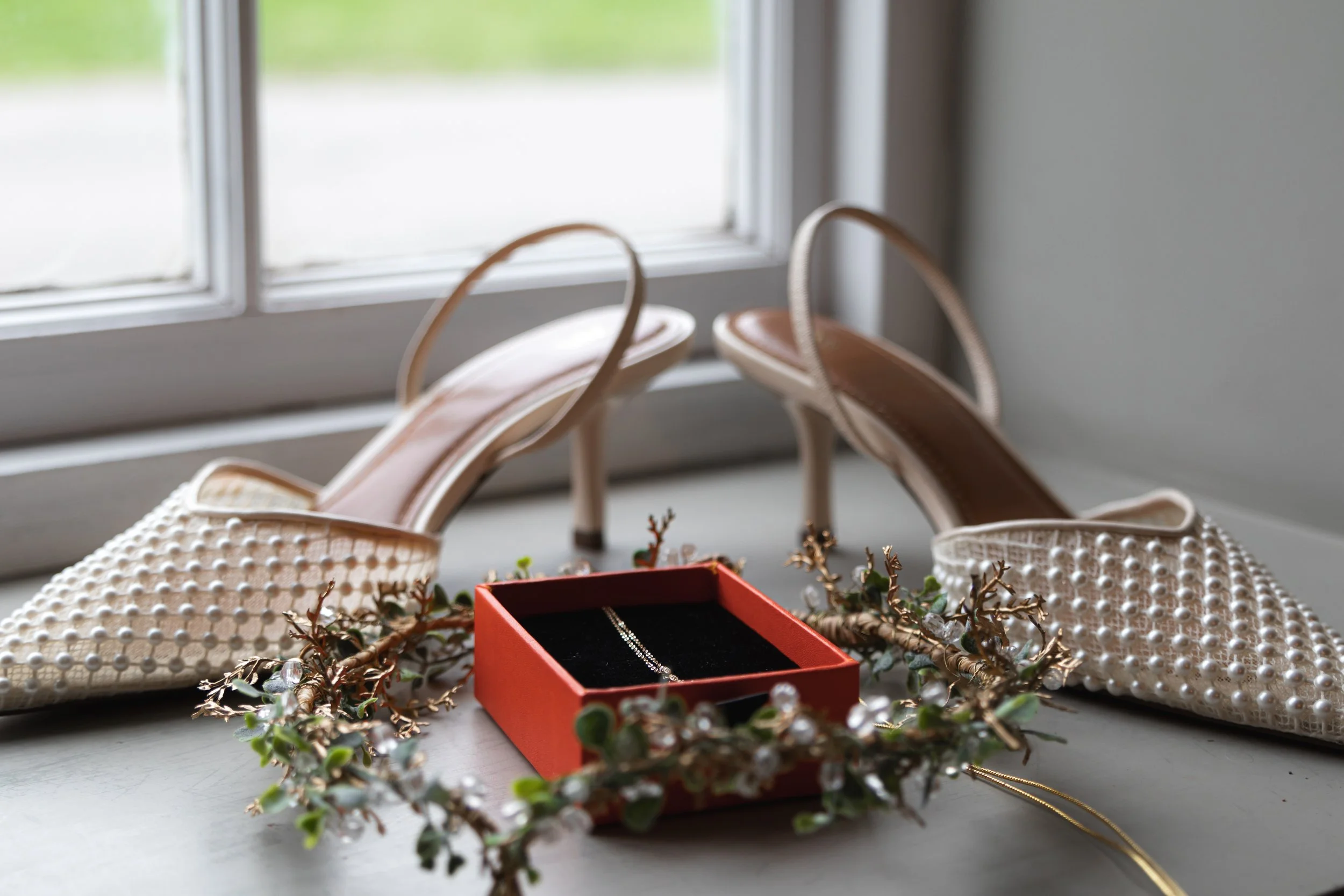 Flat lay of the bride’s shoes, jewelry, and headpiece for a Dorset wedding, captured in a detailed and elegant style.