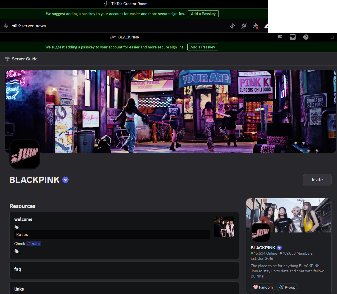 A digital screenshot of BLACKPINK's official server webpage showing a banner with photo of the K-pop girl group. The background features a scene with neon signs and women dancing in a vibrant urban setting.