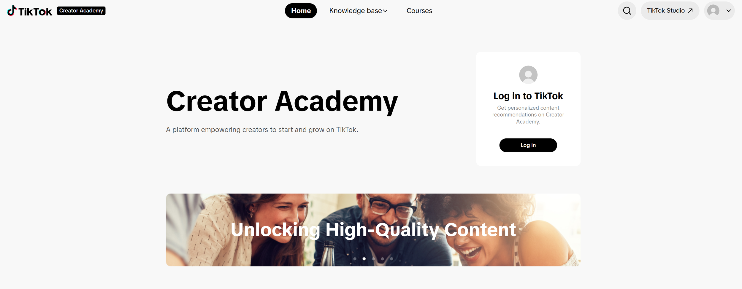 Screenshot of TikTok Creator Academy homepage showing a prominent title and a photo of three people smiling and engaging with each other.