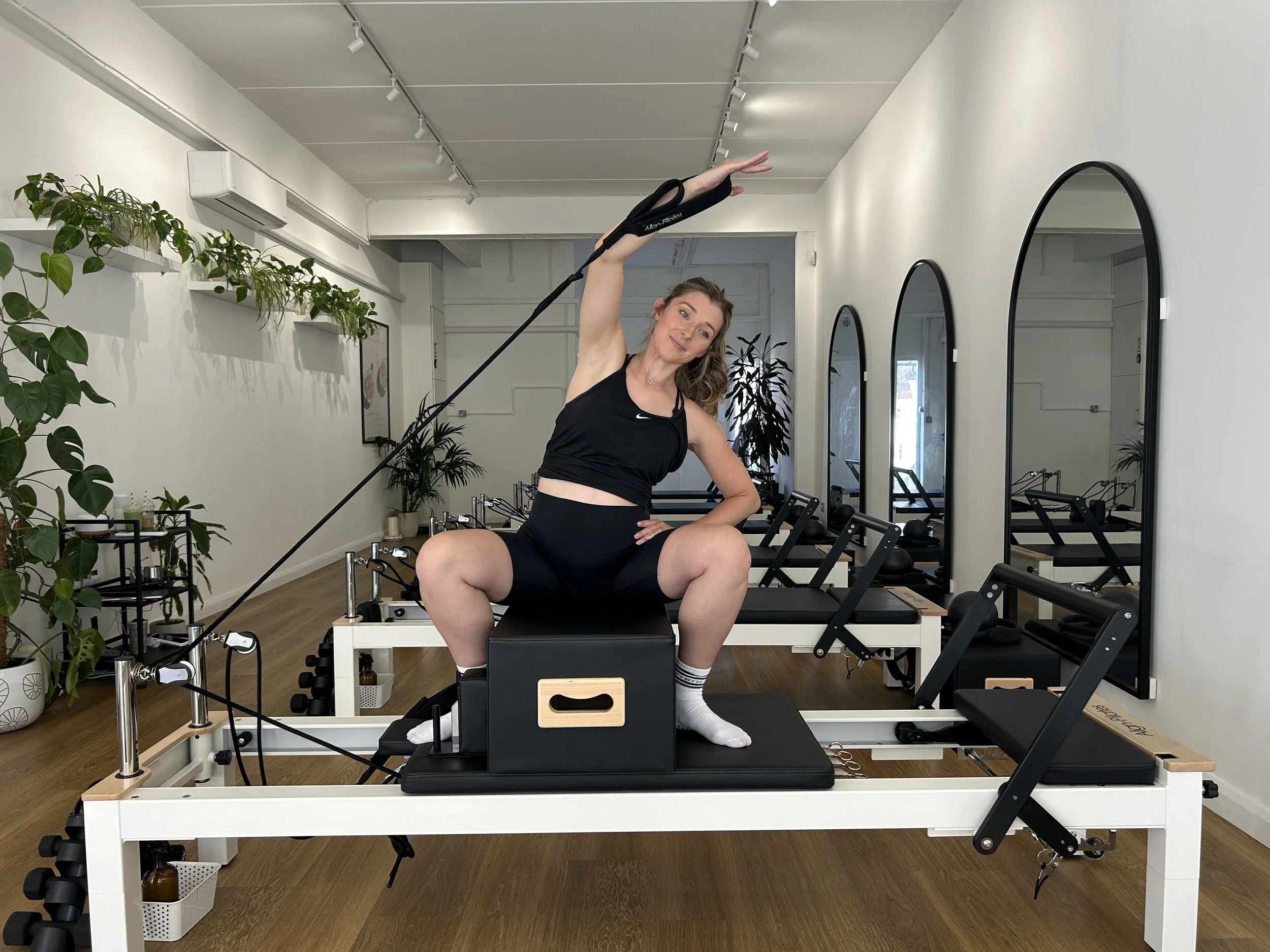 pregnant woman exercising on the reformer machine