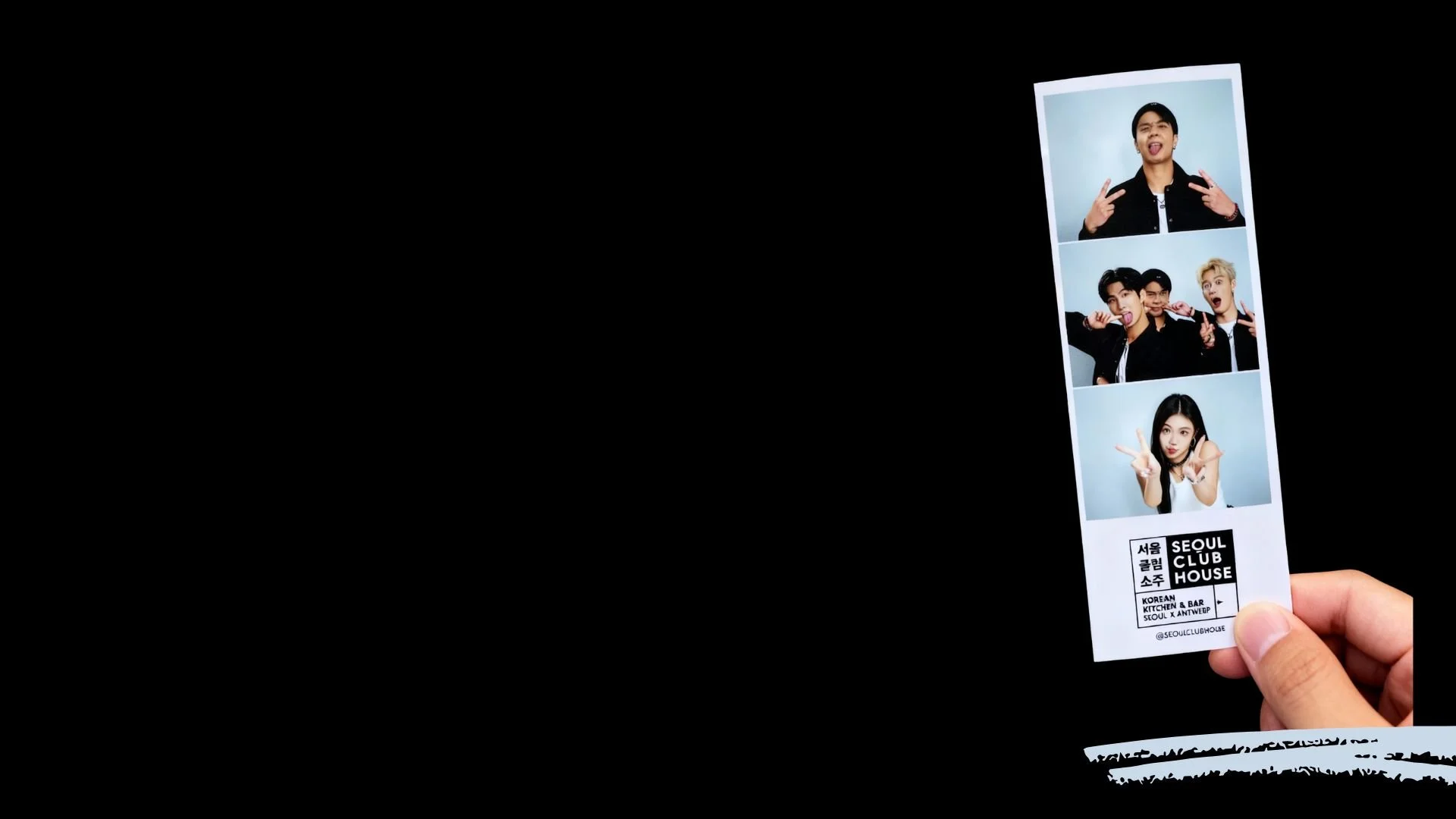 A hand holding a photo strip with three pictures of young people making playful gestures against a blue background. The photo strip has text that reads 'Seoul Club House' and information about a Korean kitchen and bar in Seoul and Antwerp.