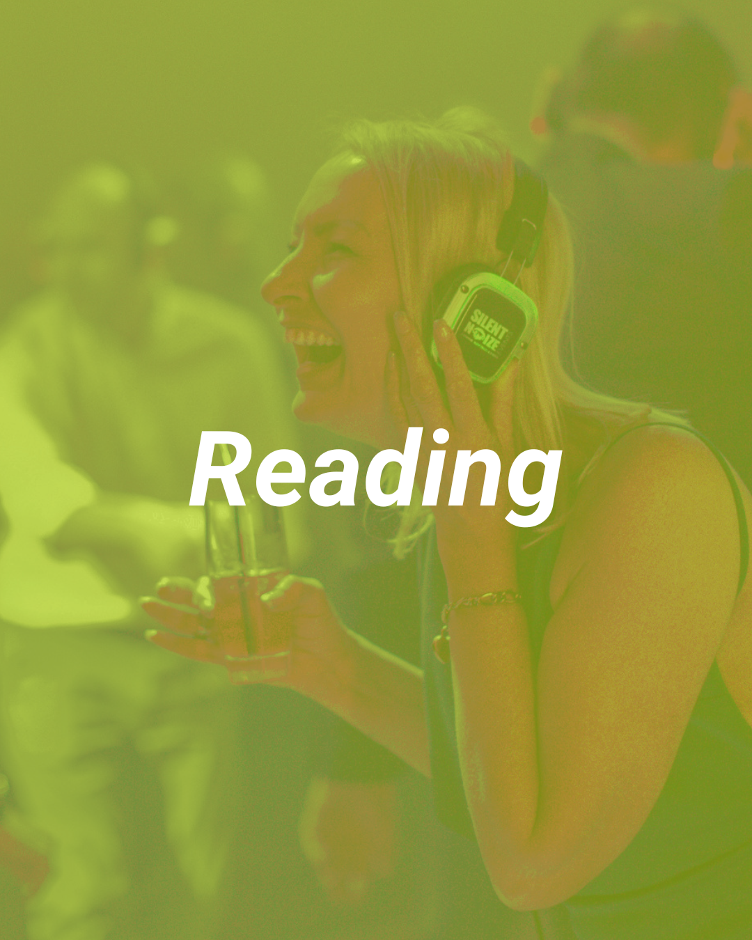 A woman with blonde hair and a big smile, wearing headphones and holding a drink, appears to be enjoying music at a social gathering.