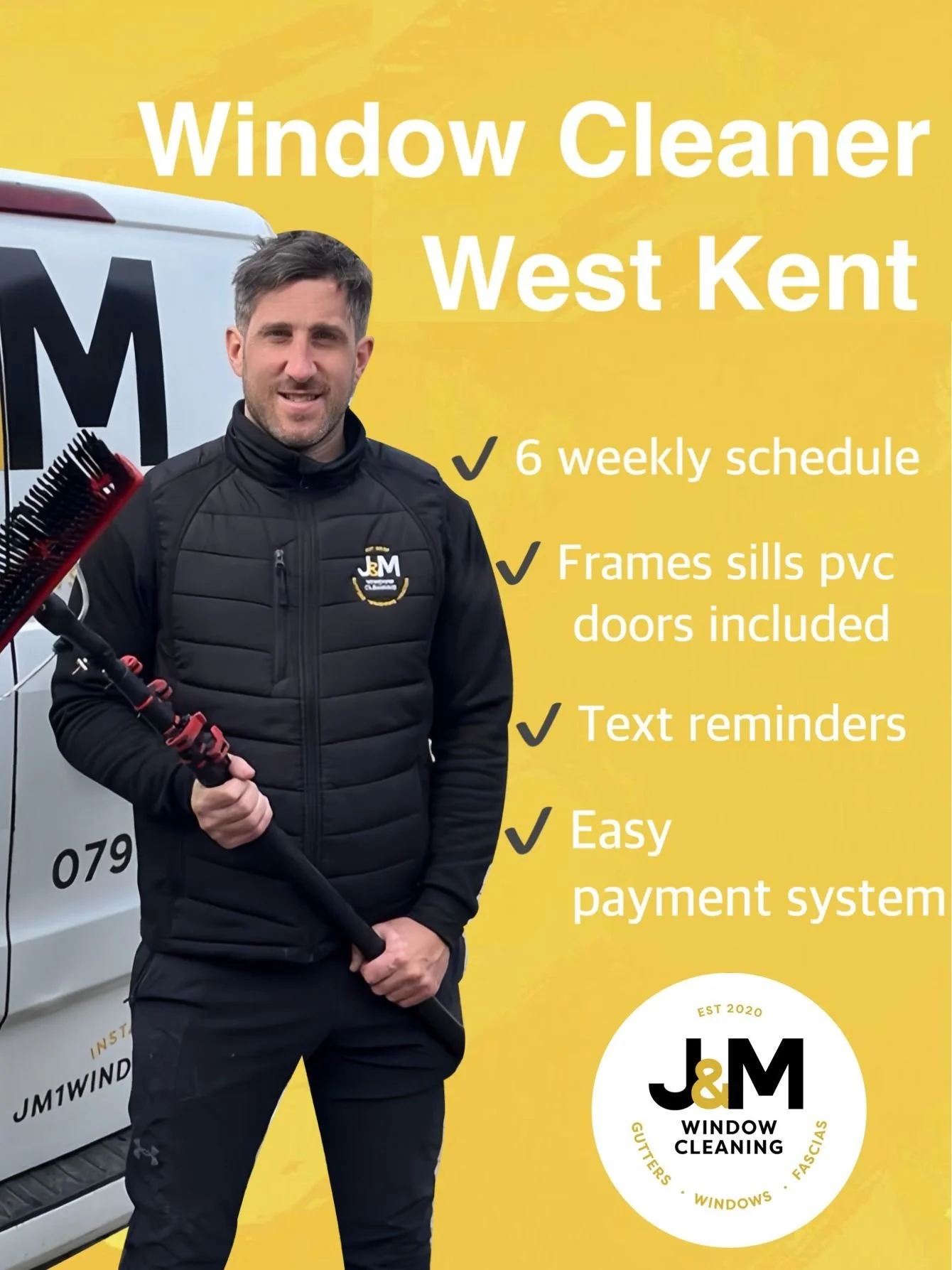 Man in black jacket holding a window cleaning brush standing in front of a yellow promotional poster for J&M Window Cleaning, West Kent, featuring services and contact details.