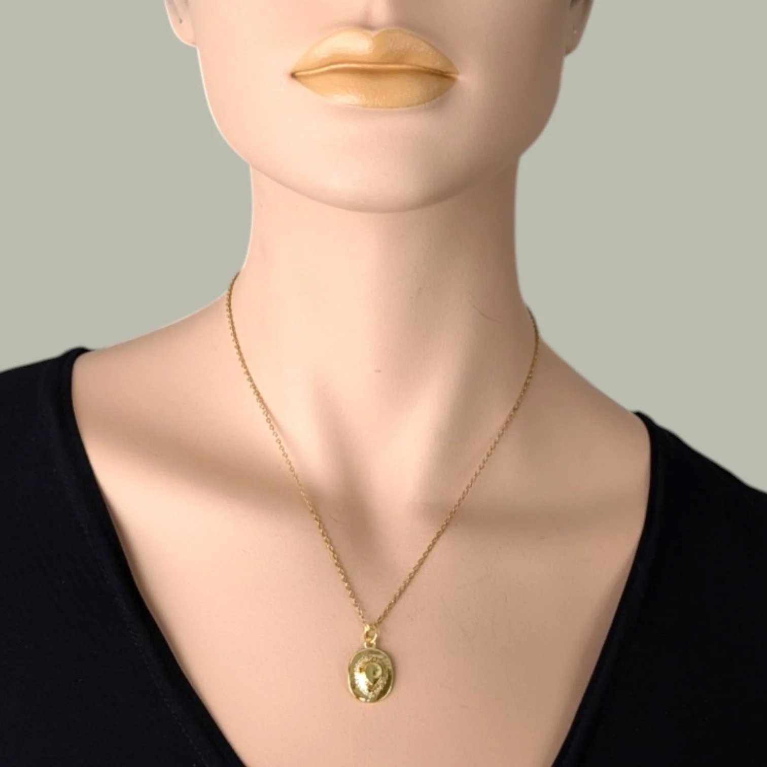 rhinestone cowboy hat necklace on a gold stainless steel chain worn on mannequin, close up bust view