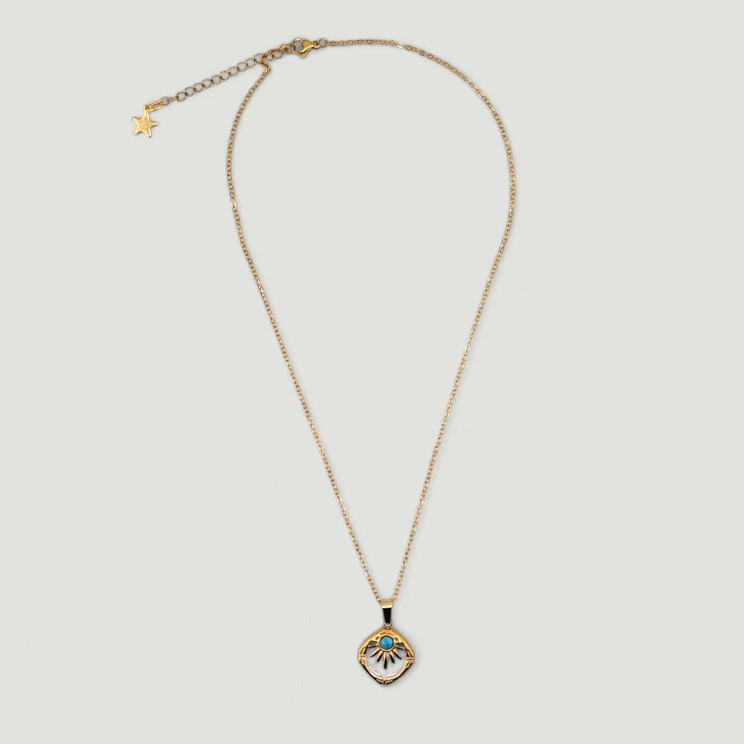 Western sunburst white enamel stainless steel necklace, gold, full view flat lay